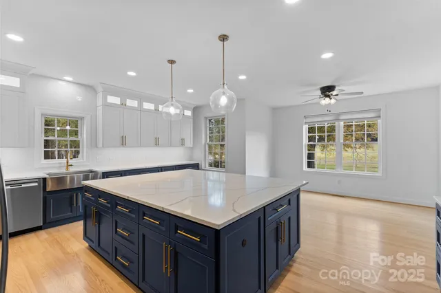 a kitchen with a stove sink and cabinets