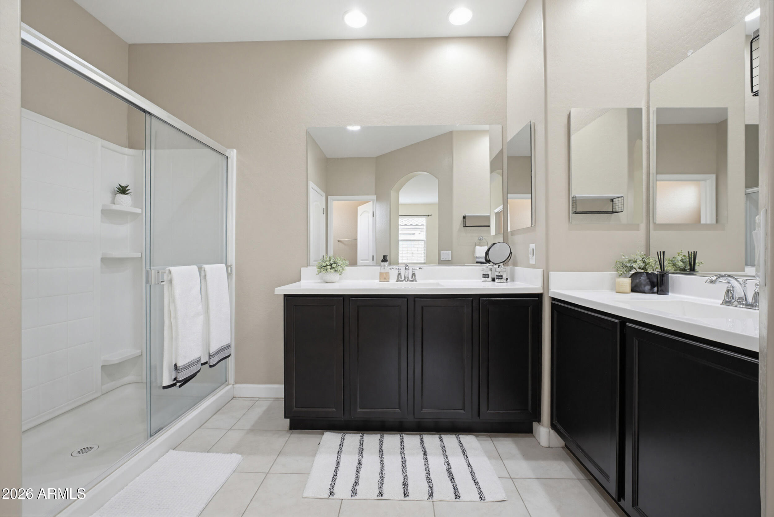 19995 North Ben Court Maricopa, AZ 85138 - Photo 28 of 51 a bathroom with a double vanity sink a mirror and a shower