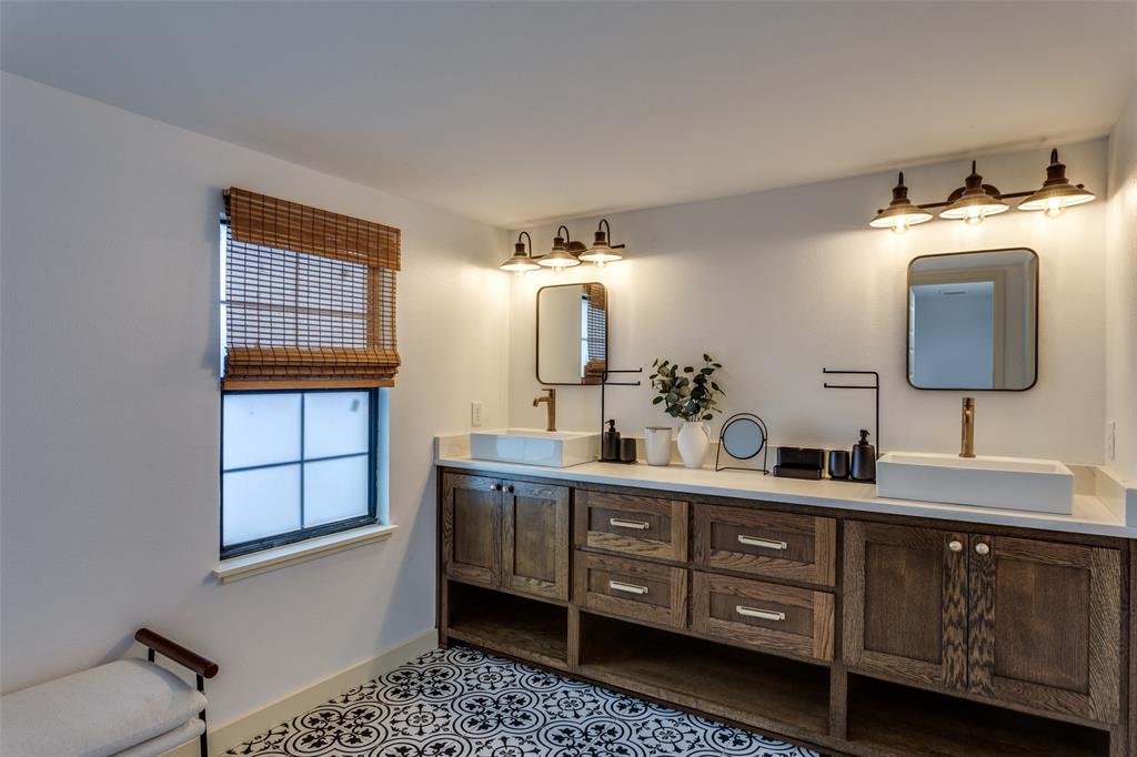 3120 Colcord Avenue Waco, TX 76707 - Photo 19 of 23 a bathroom with a double vanity sink and a mirror