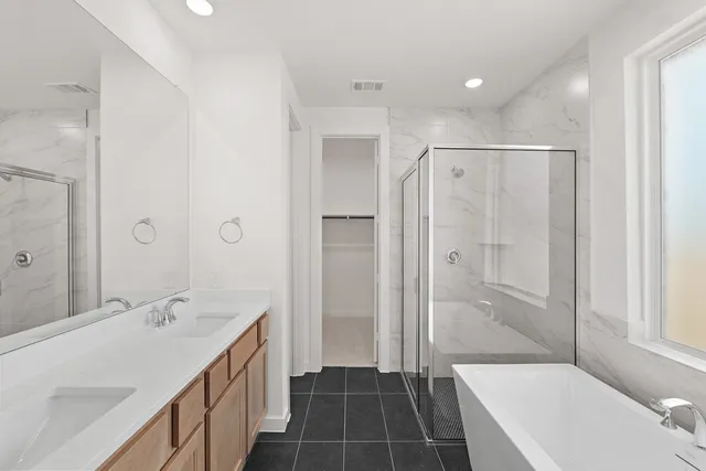 a bathroom with a tub shower sink vanity and a mirror