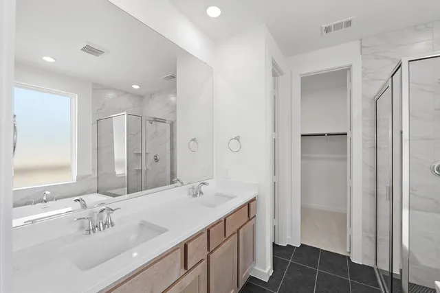 a bathroom with a double vanity sink mirror and double