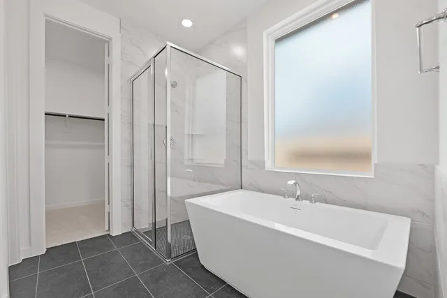 a bathroom with a bathtub and a shower