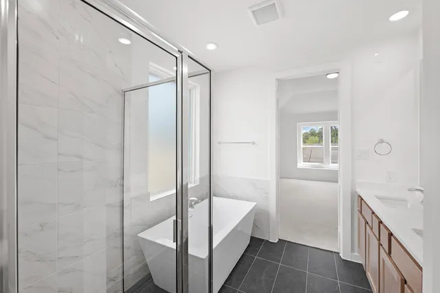a bathroom with a tub shower and sink