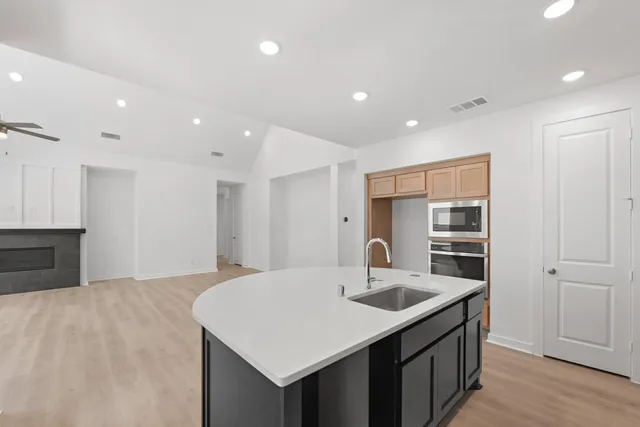 a kitchen with stainless steel appliances a sink and a refrigerator