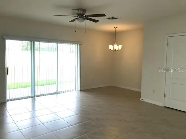 a view of an empty room and a window