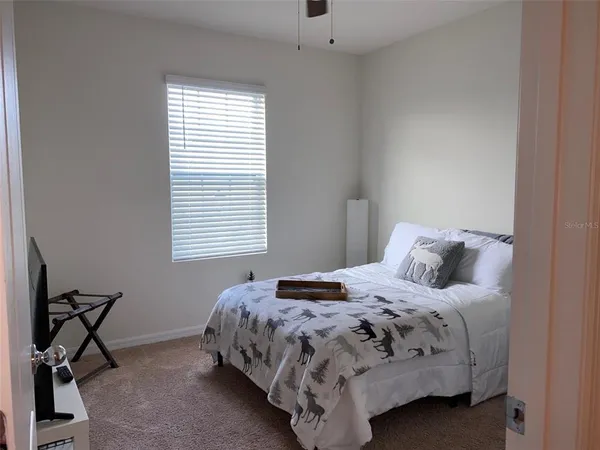 a bedroom with a bed a table and chair