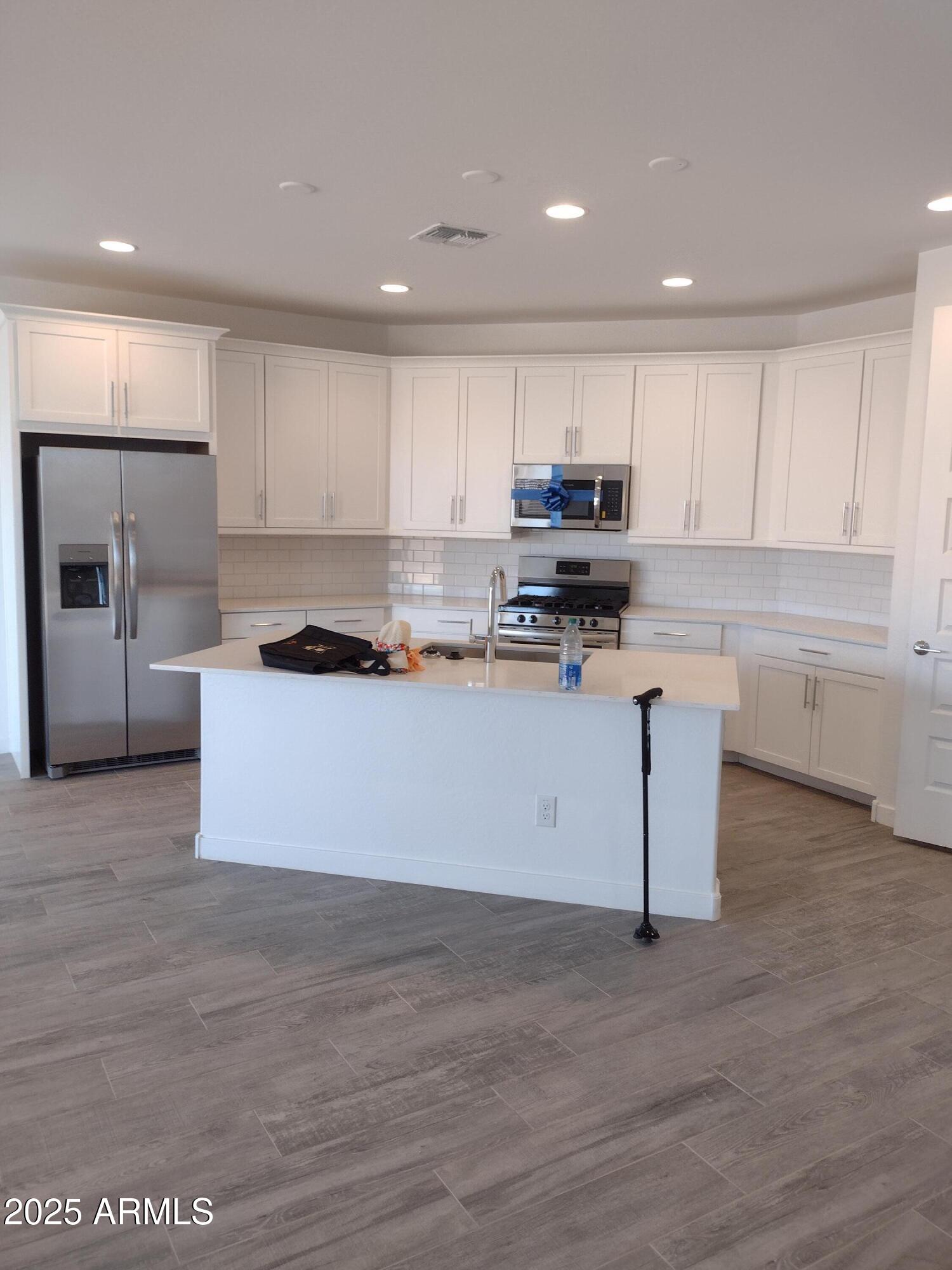 1536 West Corral Road Phoenix, AZ 85041 - Photo 2 of 16 a kitchen with a sink cabinets and stainless steel appliances
