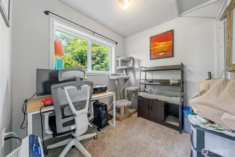 a bedroom with furniture and a flat screen tv