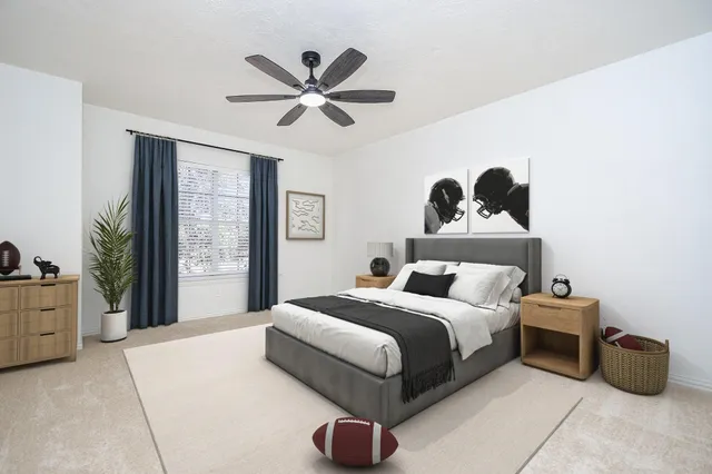 a bedroom with a bed and a painting on the wall