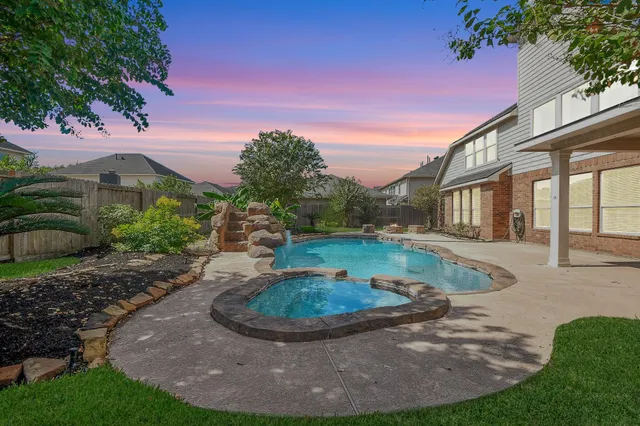 a view of a patio with couches and a fire pit