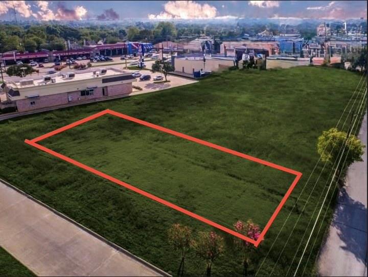 a view of a tennis ground with large trees