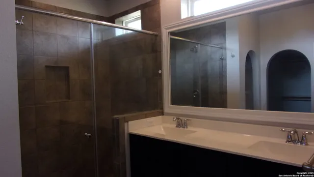 a bathroom with a sink and mirror