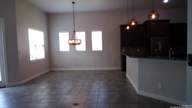 a view of an empty room with window and fireplace