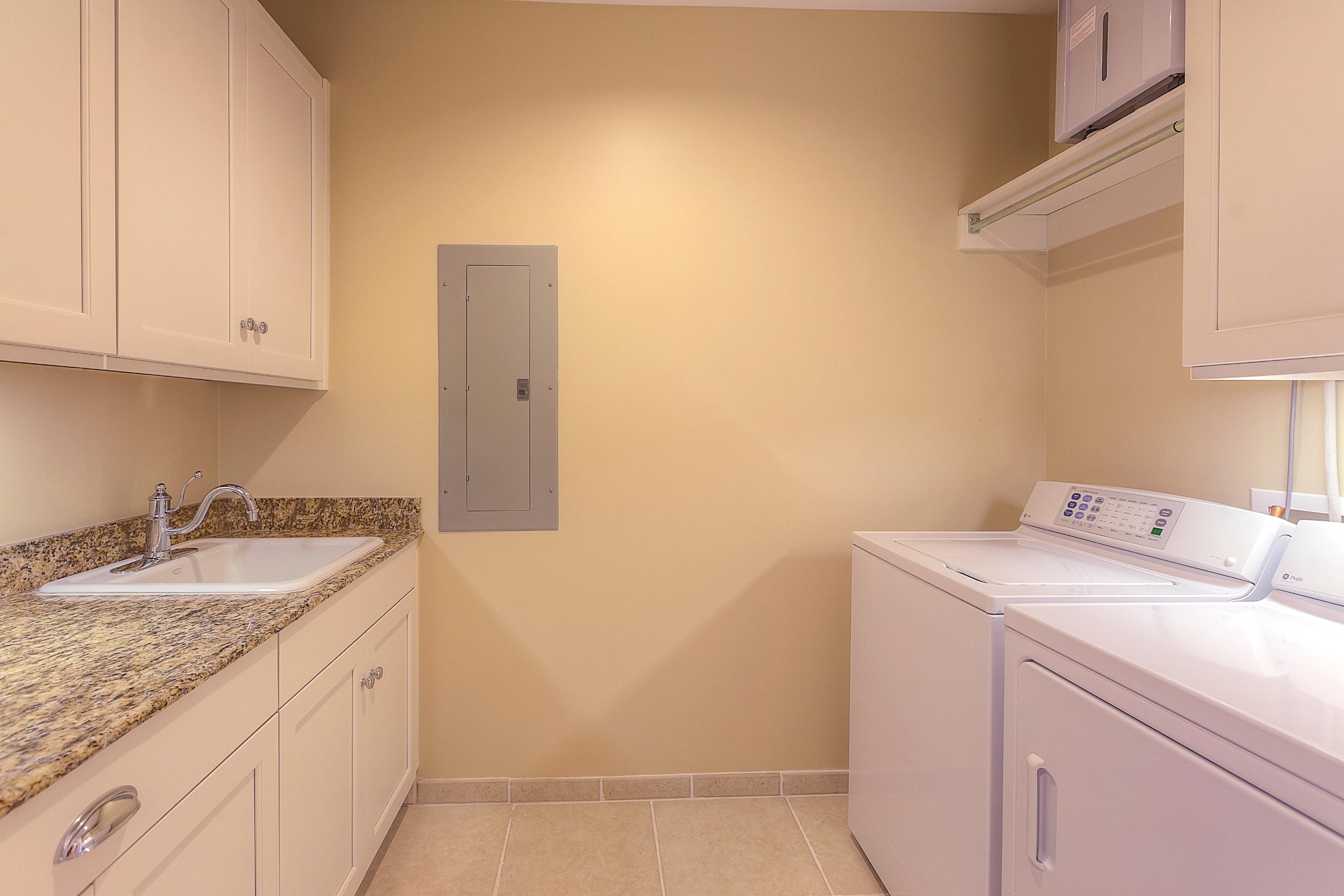 37 Compass Point Way, Unit 105 Watersound, FL 32461 - Photo 8 of 22 a utility room with a sink washer and dryer