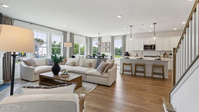 a living room with furniture a fireplace and a floor to ceiling window
