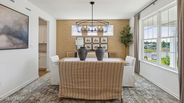 a room with stainless steel appliances kitchen island granite countertop furniture a sink a rug and a wooden floor