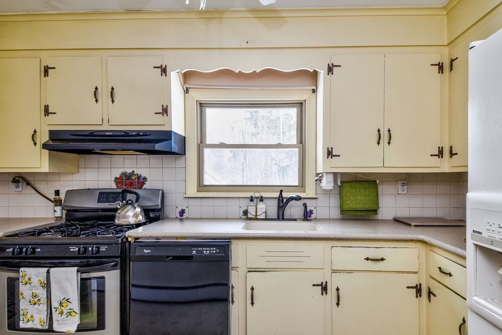 214 Great Road Stow, MA 01775 - Photo 3 of 23 a kitchen with stainless steel appliances granite countertop a stove a sink and a microwave