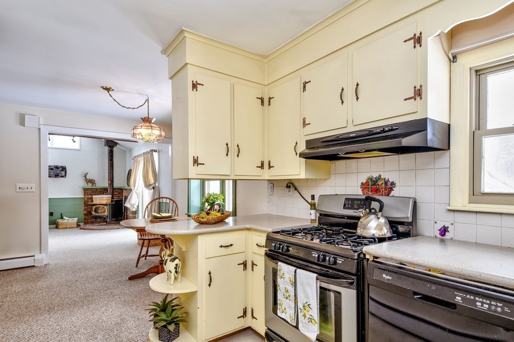 214 Great Road Stow, MA 01775 - Photo 4 of 23 a kitchen with granite countertop a stove and a white refrigerator