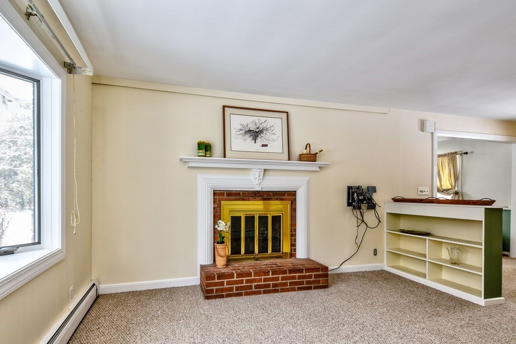 214 Great Road Stow, MA 01775 - Photo 8 of 23 a living room with furniture and a fireplace