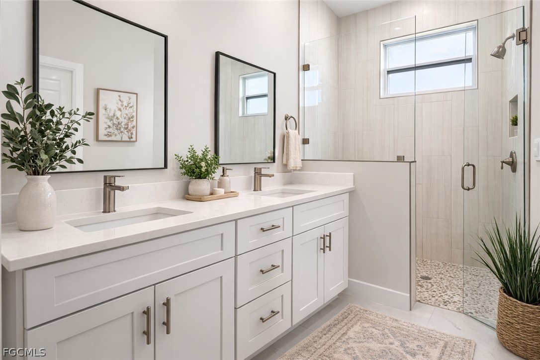 3002 Mercer Way LaBelle, FL 33935 - Photo 20 of 38 a bathroom with double vanity a mirror and a shower