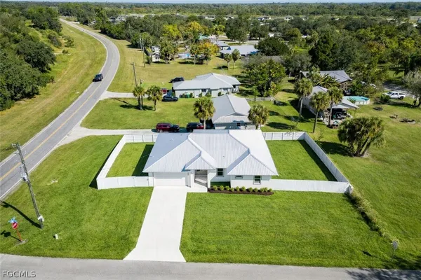 a kitchen with stainless steel appliances a refrigerator a stove a dining table and chairs