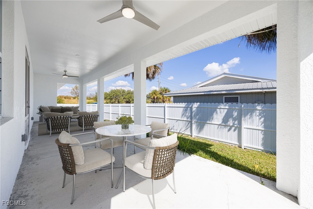 3002 Mercer Way LaBelle, FL 33935 - Photo 27 of 38 a dining room with furniture and a floor to ceiling window