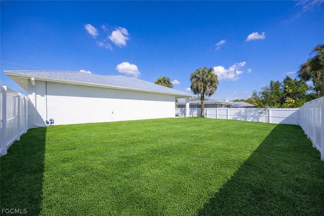 3002 Mercer Way LaBelle, FL 33935 - Photo 29 of 38 a view of a back yard with a large tree front of the house
