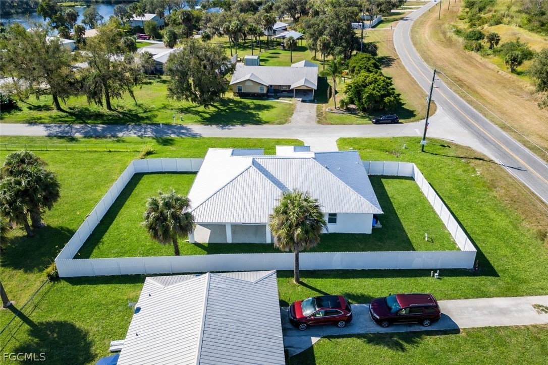 3002 Mercer Way LaBelle, FL 33935 - Photo 32 of 38 a view of swimming pool with lawn chairs and a yard