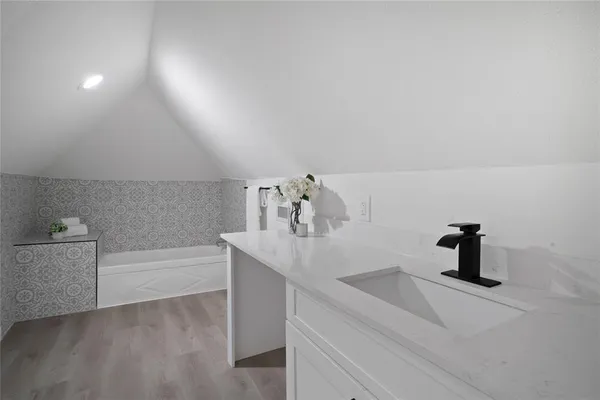 a bathroom with a sink and mirror
