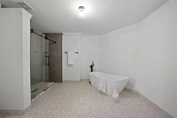 a spacious bathroom with a bathtub and toilet
