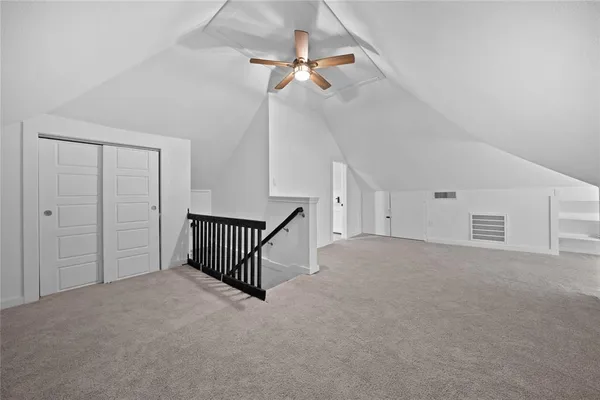 a view of a livingroom with a ceiling fan and window
