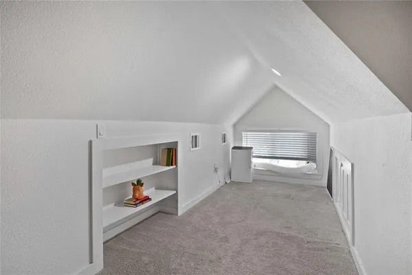 a view of a room with wooden floor and cabinet