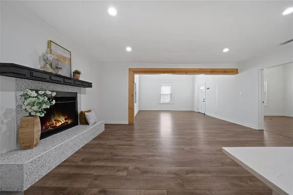 a view of a room wooden floor and fire place