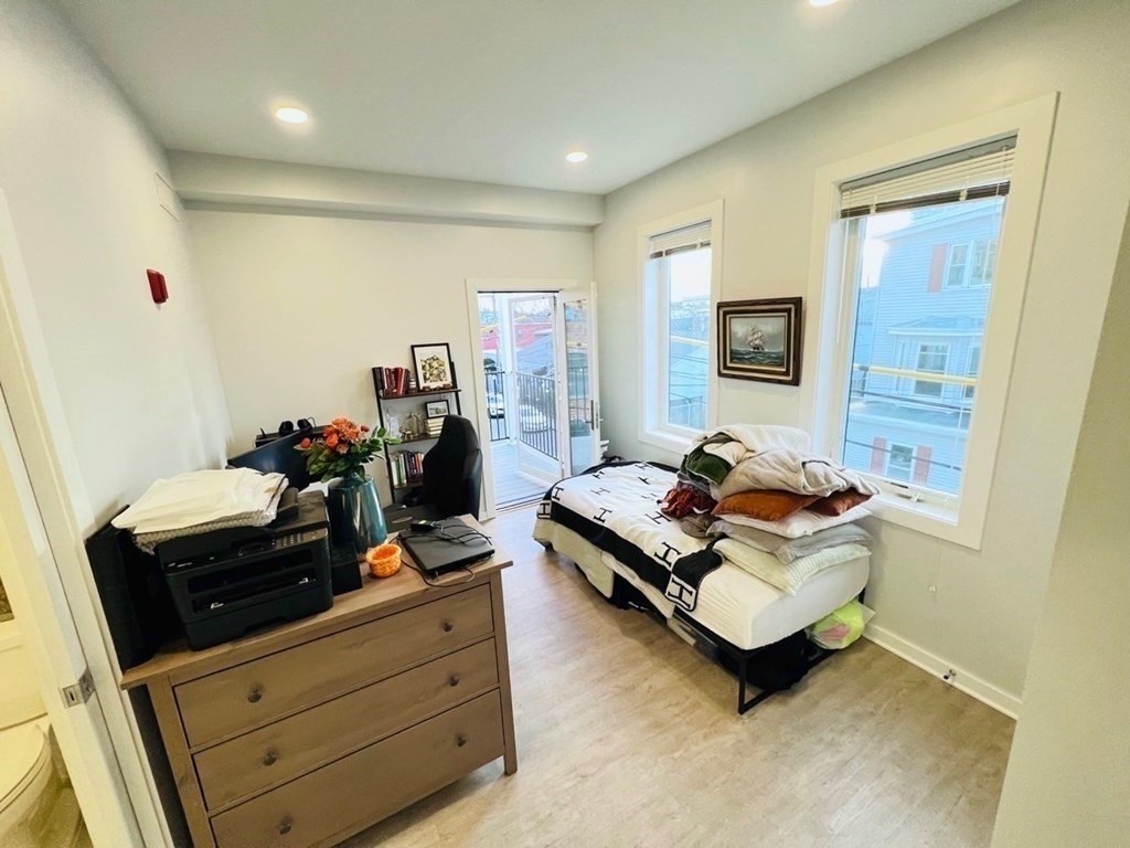 14 Ward Street, Unit 102 Somerville, MA 02143 - Photo 18 of 26 a living room with furniture and a flat screen tv