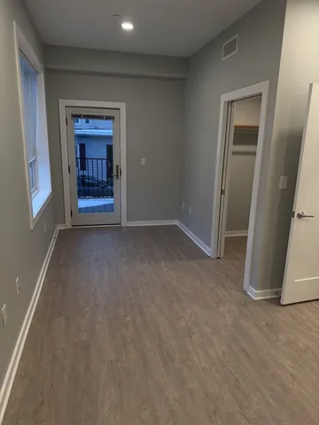 an empty room with a fireplace and cabinet