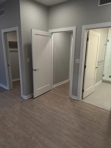 an empty room with closet and mirror
