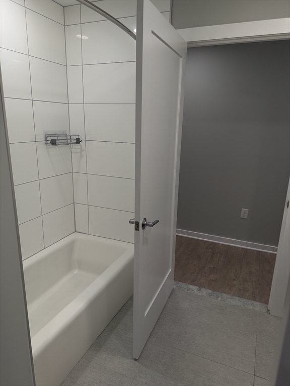 14 Ward Street, Unit 102 Somerville, MA 02143 - Photo 24 of 26 a white bath tub sitting in a bathroom