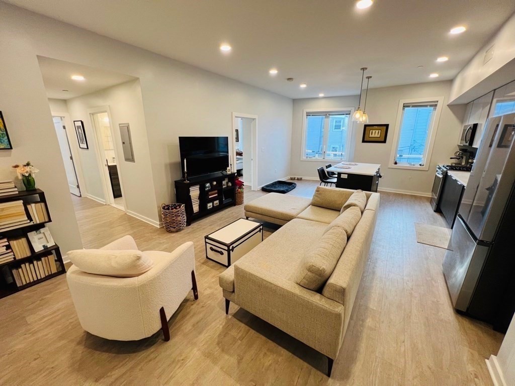 14 Ward Street, Unit 102 Somerville, MA 02143 - Photo 3 of 10 a living room with furniture and a flat screen tv