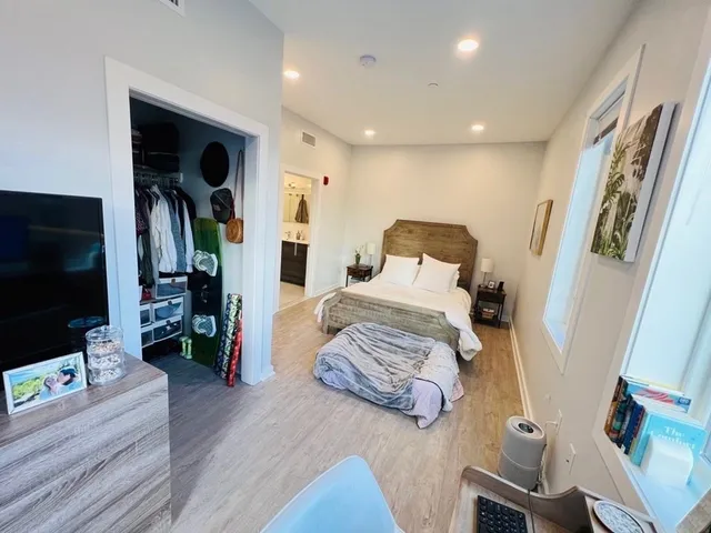 a bedroom with furniture and a flat screen tv