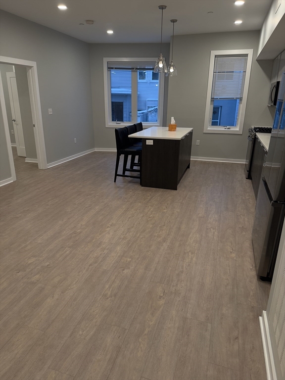 14 Ward Street, Unit 102 Somerville, MA 02143 - Photo 8 of 26 a room with furniture and a flat screen tv