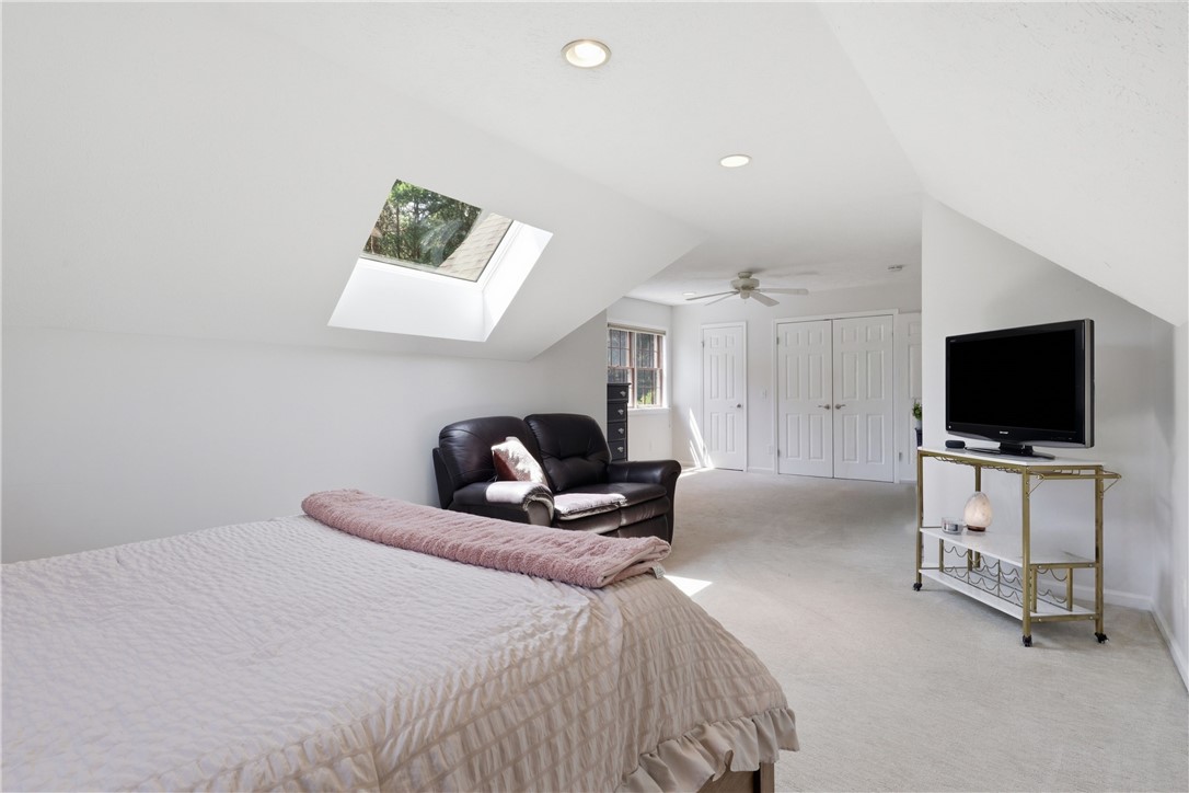 2057 Stirnie Road Victor, NY 14564 - Photo 48 of 48 Another perspective of the grand upper bedroom highlights its generous floor plan, providing ample room for a king-sized bed set and an integrated sitting or dressing area alongside dedicated closet storage.