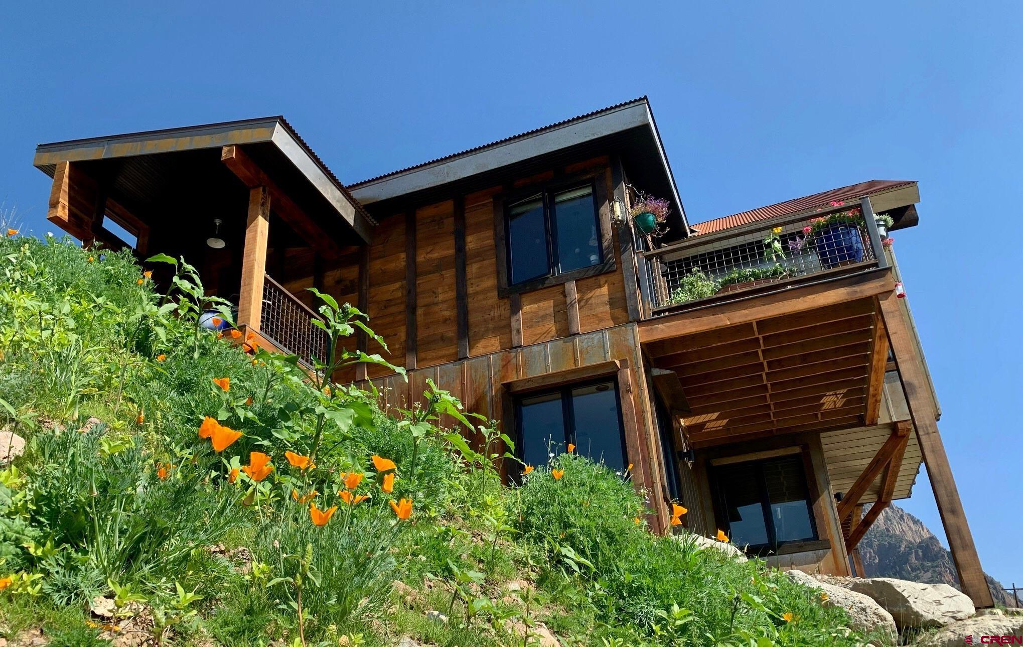 49 Silver Drive Creede, CO 81130 - Photo 3 of 4 a front view of a house with garden