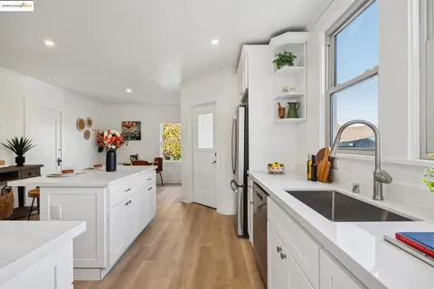 a kitchen with stainless steel appliances a stove refrigerator sink and cabinets