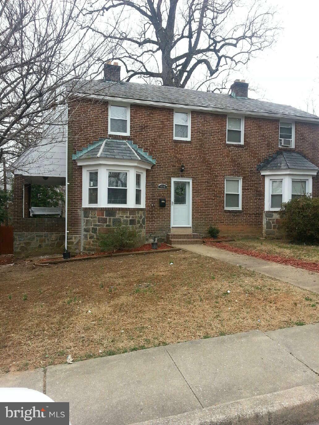 414 North Bend Road Baltimore, MD 21229 - Photo 2 of 27 a front view of a house with a yard and garage