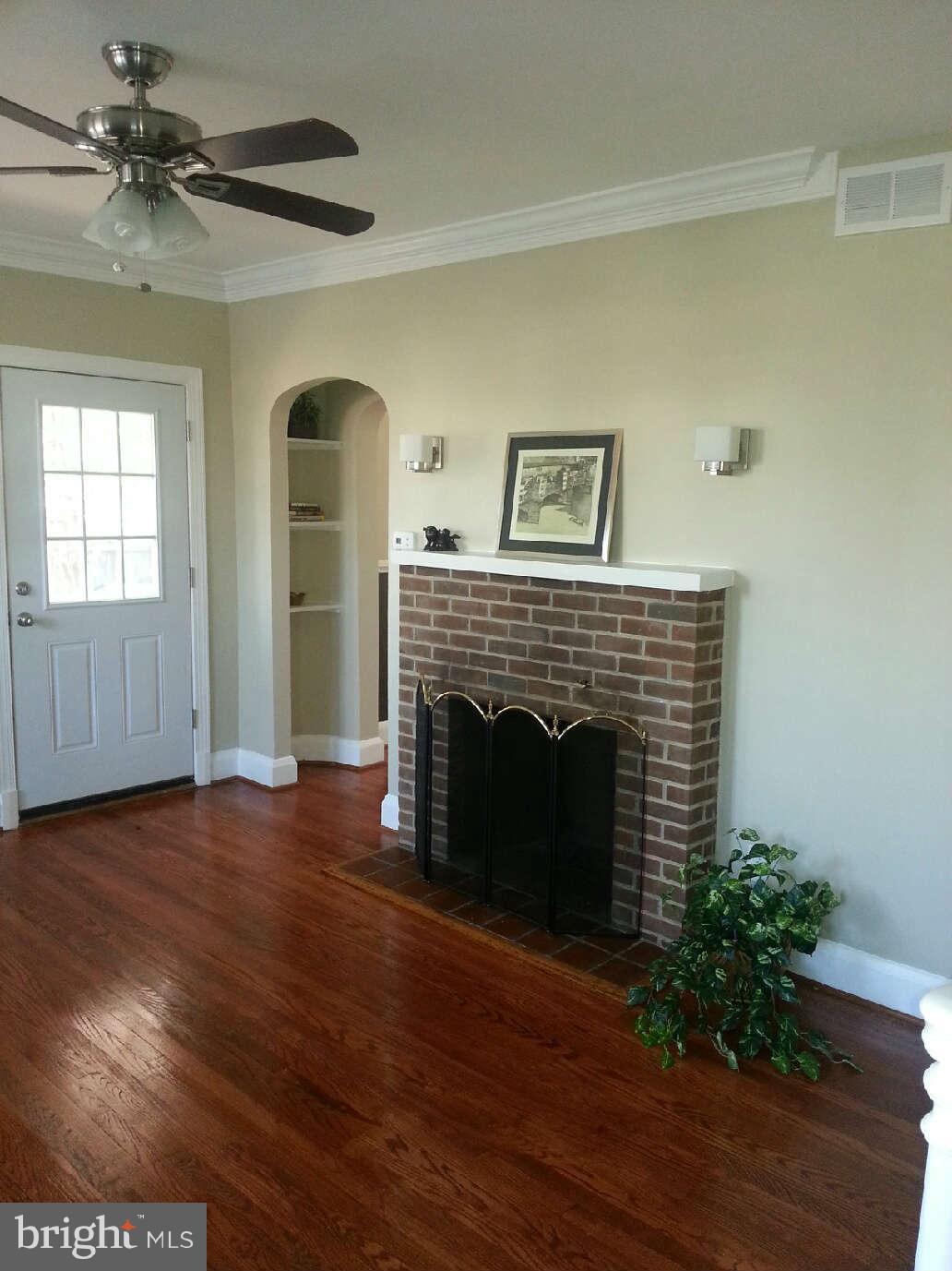 414 North Bend Road Baltimore, MD 21229 - Photo 20 of 27 a view of an empty room with wooden floor and a fireplace