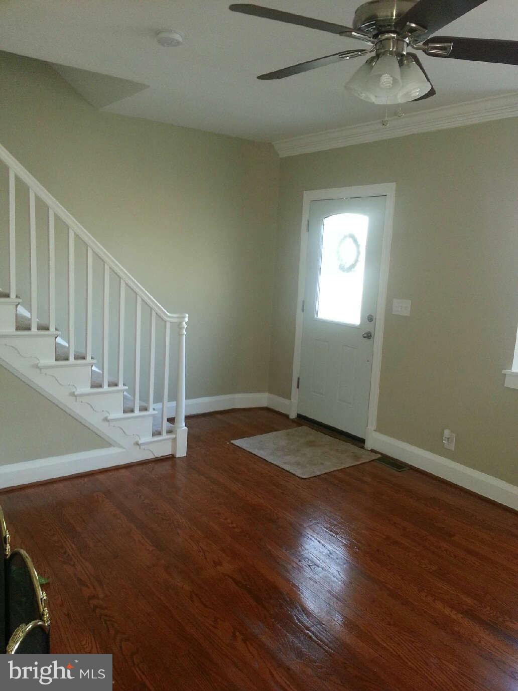414 North Bend Road Baltimore, MD 21229 - Photo 21 of 27 an empty room with wooden floor fan and windows
