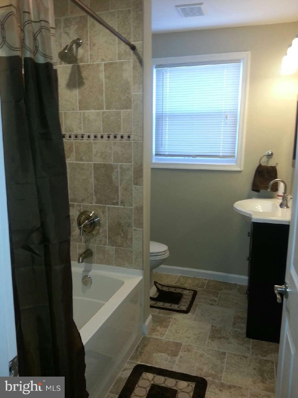 414 North Bend Road Baltimore, MD 21229 - Photo 22 of 27 a bathroom with a sink a toilet and shower