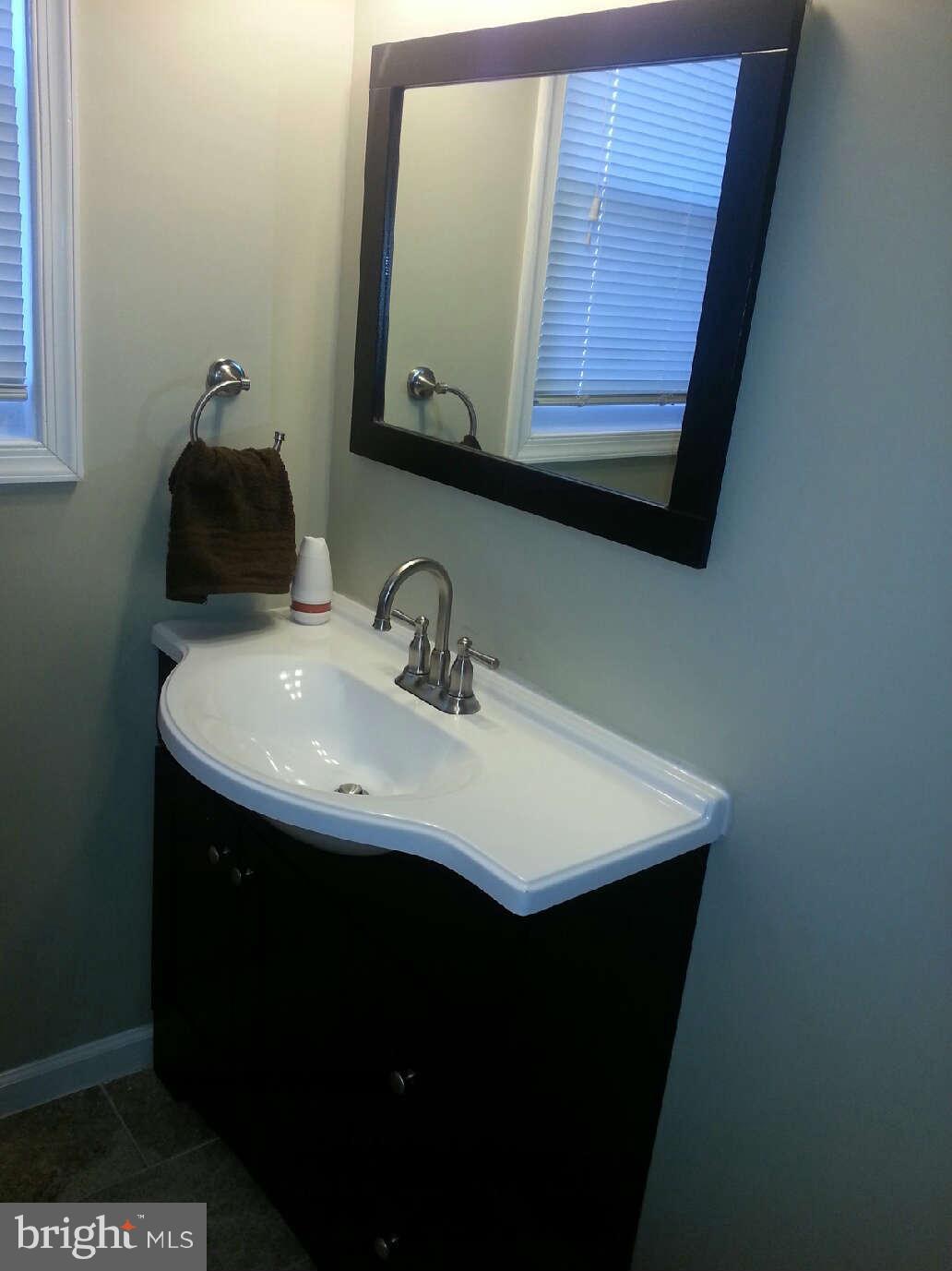 414 North Bend Road Baltimore, MD 21229 - Photo 23 of 27 a bathroom with a sink and a mirror