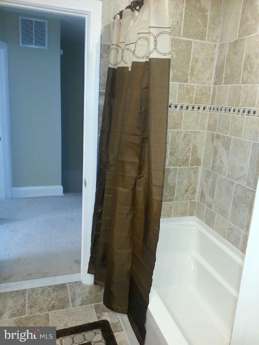 414 North Bend Road Baltimore, MD 21229 - Photo 9 of 27 a bathroom with a shower and a tub