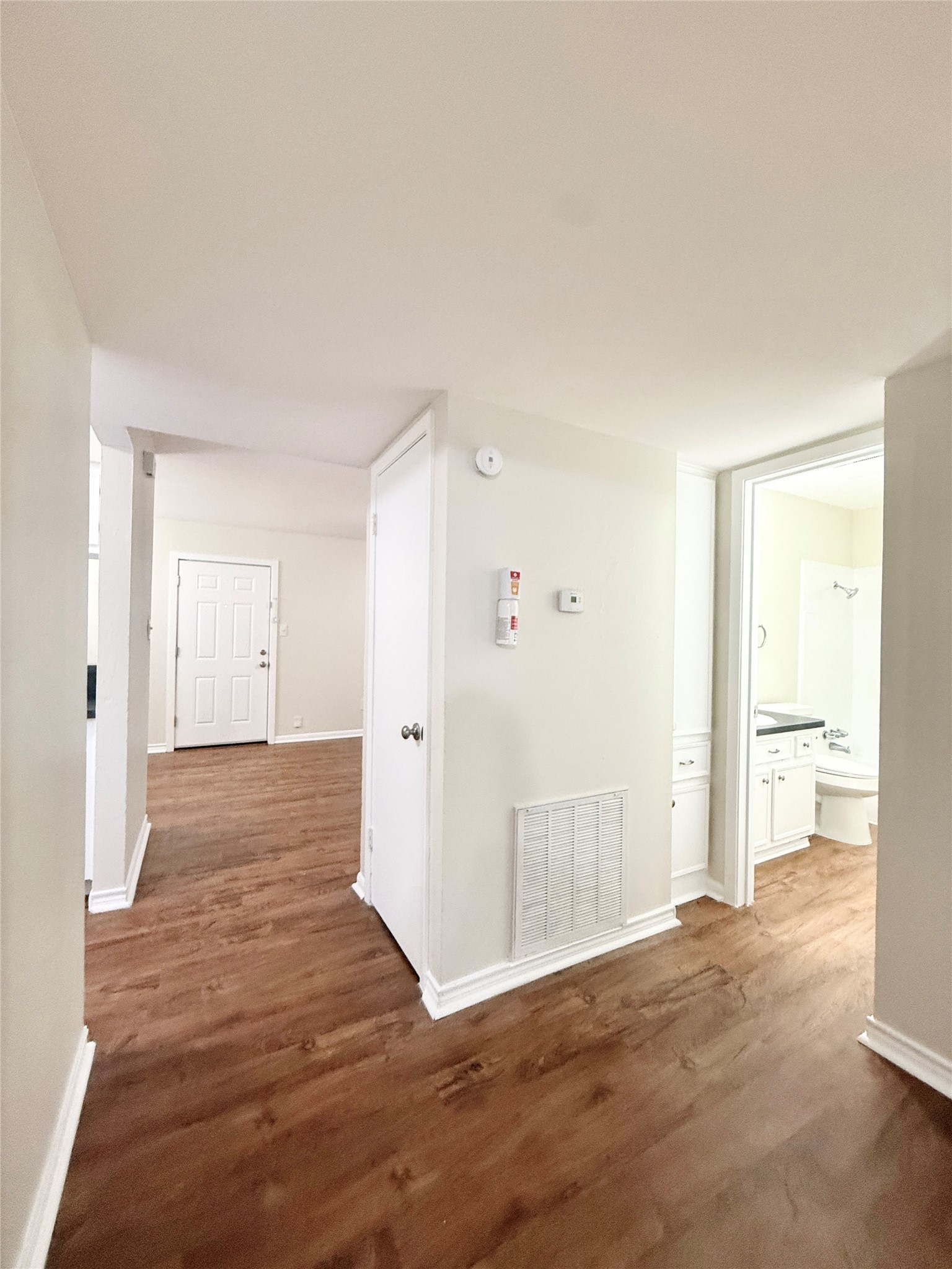 321 East Cedar Street, Unit 7 Angleton, TX 77515 - Photo 12 of 16 a view of a room with wooden floor and bathroom